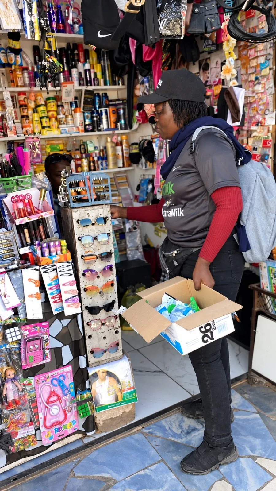 Brand ambassador visiting a shop with a box of Nutra Milk